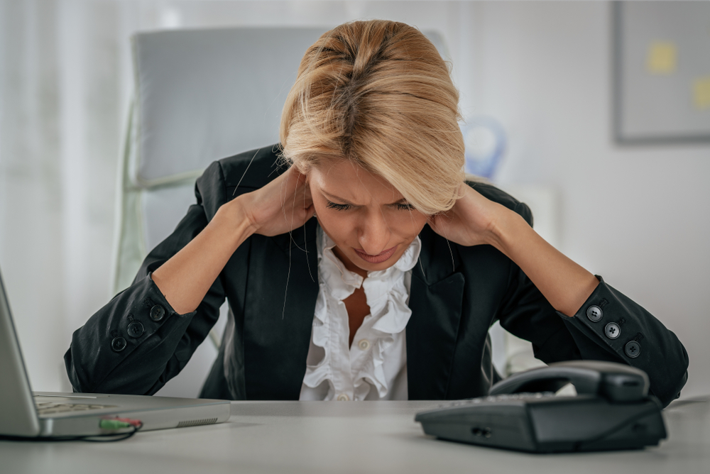 image of a Young tired businesswoman with neck pain