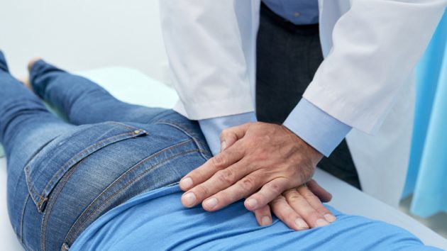 image of a Chiropractor doing pushing motion to adjust back