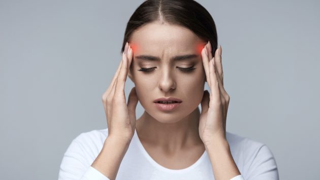 Image of a Beautiful Young Woman Feeling Strong Head Pain