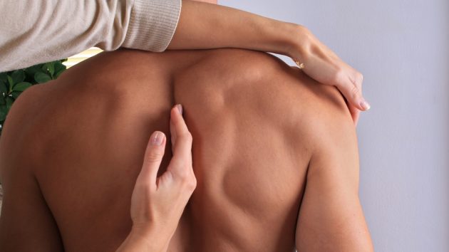 Image of a Man having chiropractic back adjustment