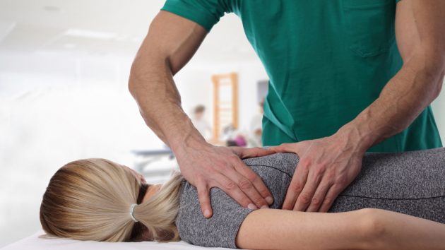 image of a Woman having chiropractic back adjustment