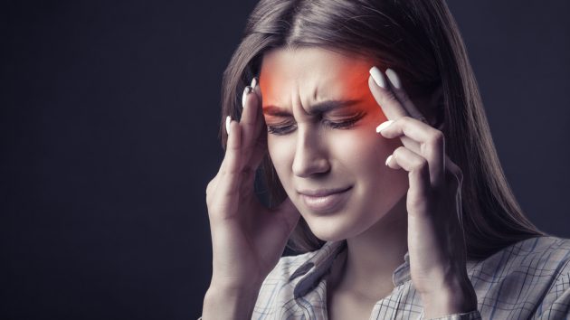 image of a Young woman is suffering from a headache